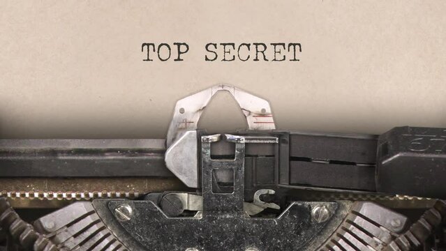 Old retro typewriter with sheet of paper. Close up. Words. Writing text Top Secret. With machine sounds. 29,97 fps