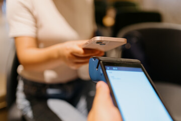 woman pay with smartphone