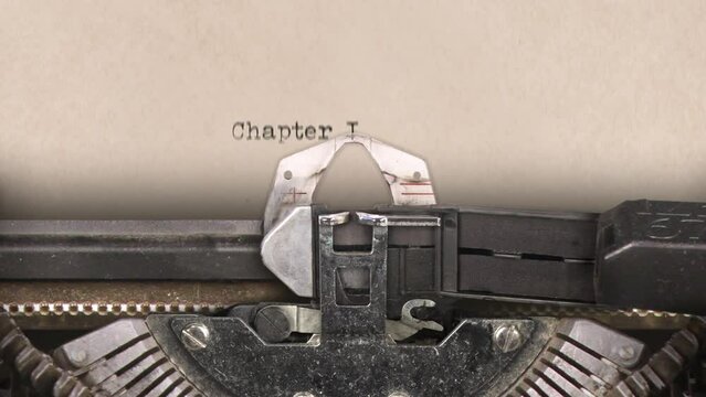 Old retro typewriter with sheet of paper. Close up. Words. Writing text Chapter I. Machine sounds.