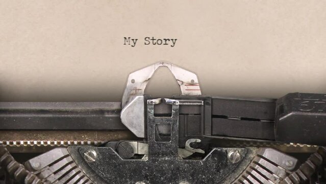 Old retro typewriter with sheet of paper. Close up. Writing the words My Story. With machine sounds. 25fps