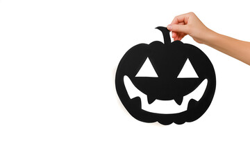 Close up of female hand holding big black paper spooky pumpkin, isolated over white studio background wall with copy space for promotion content or design. Concept for Happy Halloween holiday