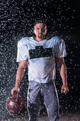 American Football Field: Lonely Athlete Warrior Standing on a Field Holds his Helmet and Ready to...