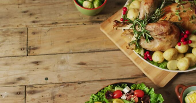 Video of tray with roasted turkey, potatoes and vegetable on wooden surface