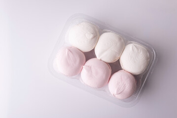 pink and white marshmallows packed on a white background