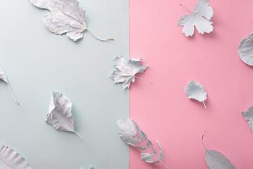 Autumn botanical background with copy space. autumn background autumn leaves in blue paint on pink