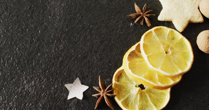 Video of christmas decoration with spices and copy space on slate background