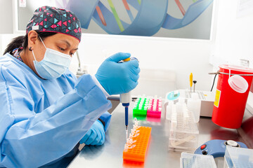 Female scientist extracting DNA using the spin column-based nucleic acid purification technique