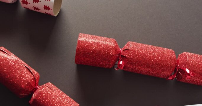Video of red and white christmas crackers on grey background