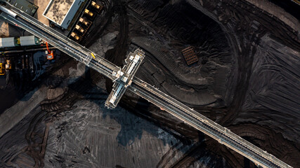 Aerial top view moving belt with heap of coal next to the coal power plant, Coal mining view from above, © Darunrat