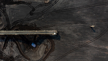 Aerial top view moving belt with heap of coal next to the coal power plant, Coal mining view from above, © Darunrat