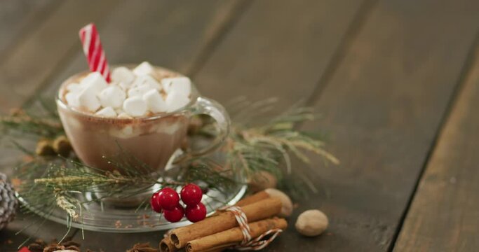 Video of cup of hot chocolate with marshmallows over wooden background