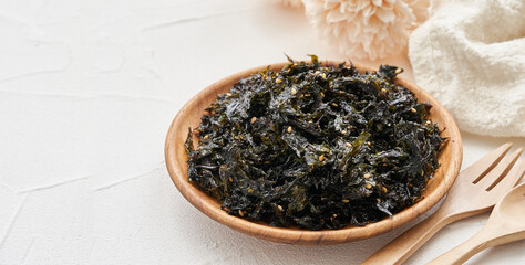 roasted nori seaweed and sesame topping in wood plate on white background. Gim, laver, nori                 