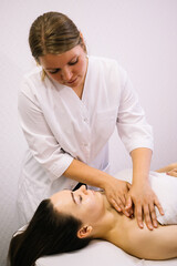 Woman receiving facial massage in beauty salon.Beauty and skincare concept with a beautiful woman. Middle aged female relaxed with massage for facial lifting	