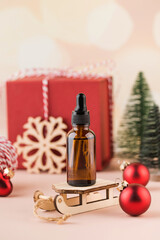  Anti-aging cosmetic product, moisturizing facial serum in a brown dropper on a christmas background. 