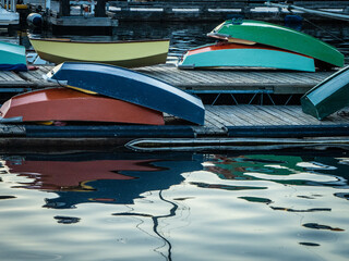 Fototapeta na wymiar colorful small wooden boats stacked on a dock
