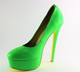 Bright green stiletto shoe with a platformed yellow sole 