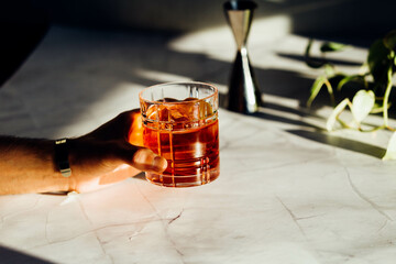 Man hand with a negroni aperitif cocktail