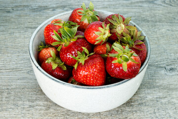 Red strawberry organic fruits in a bowl. Fresh berries fruit snack.