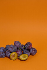 Blue Plums on orange background