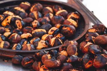 Hot chestnuts roasted on a grill with their skin on. Close-up. Turkey, Istanbul. Selective Focus