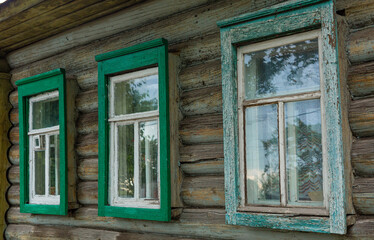 The beautiful old windows with beautifully designed platbands window on an old wooden house in the city of Tula