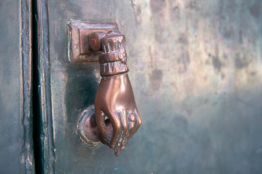 vintage hand doorknocker on entrace
