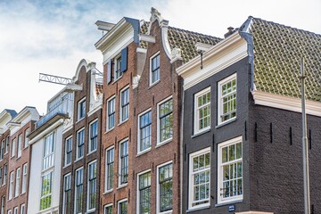 Details and facades of Amsterdam characteristic brick construction of residential building in...