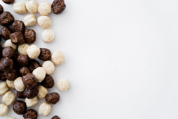 top view of cereal balls with vanilla and chocolate flavors isolated on white.