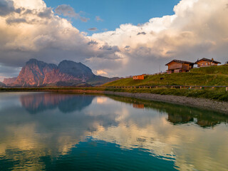 Fototapeta premium Sunrise in the Dolomites mountains with fog and mist rolling around the peaks. Hiking path leading to the hills. 
