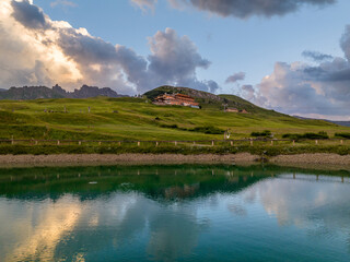 Sunrise in the Dolomites mountains with fog and mist rolling around the peaks. Hiking path leading to the hills. 