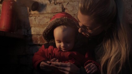 War in Ukraine. Ukrainian genocide. Bomb shelter. Ukrainian mother and baby in the basement....