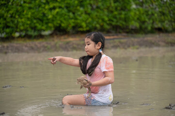 Asian children girl in farm frog
