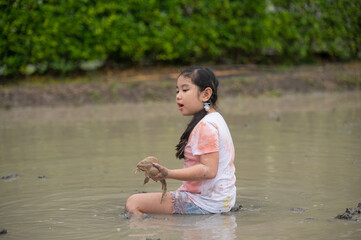 Asian children girl in farm frog