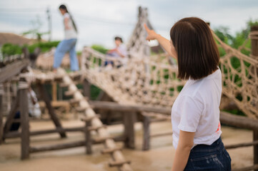 Asian woman happy teacher standing on  playground background