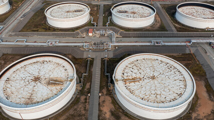 Aerial view crude oil storage tank, White storage tank farm chemical petroleum petrochemical refinery product, oil and gas fuel storage crude energy silos terminal. © Darunrat