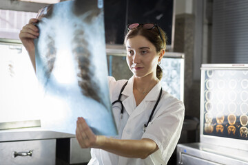 Female doctor checking anatomy and physiology x-ray film of patient in the hospital