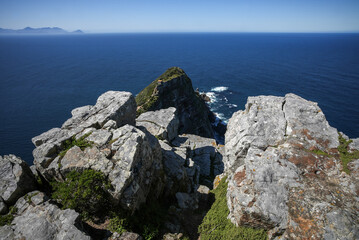 Rugged rock shapes on a cliff top at Cape Point with the deep blue sea and horizon in the background, Western Cape.
