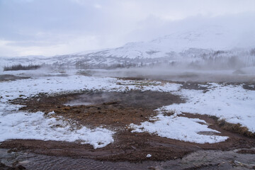 Geothermal fields Hverir. Spectacular landscape of volcanic terrain with geothermal activity in Iceland, nearby famous Hot Spring Gaysir and Strokkur, Golden Circle tourist itinerary.