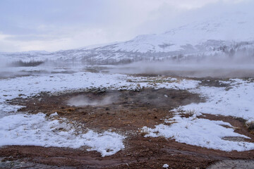 Geothermal fields Hverir. Spectacular landscape of volcanic terrain with geothermal activity in Iceland, nearby famous Hot Spring Gaysir and Strokkur, Golden Circle tourist itinerary.