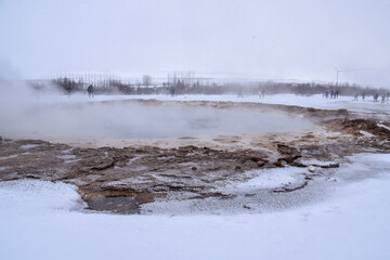 Geothermal fields Hverir. Spectacular landscape of volcanic terrain with geothermal activity in Iceland, nearby famous Hot Spring Gaysir and Strokkur, Golden Circle tourist itinerary.
