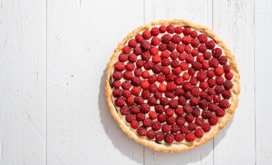 homemade raspberry pie with shadow, view from above, copy space