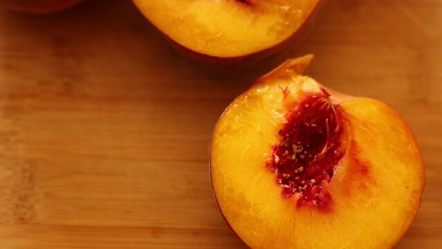 Ripe peaches on wooden board close up