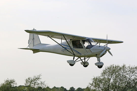 Ultralight airplane flying in a blue sky