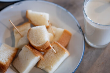 Sliced bread to eat with custard and fresh milk for breakfast.