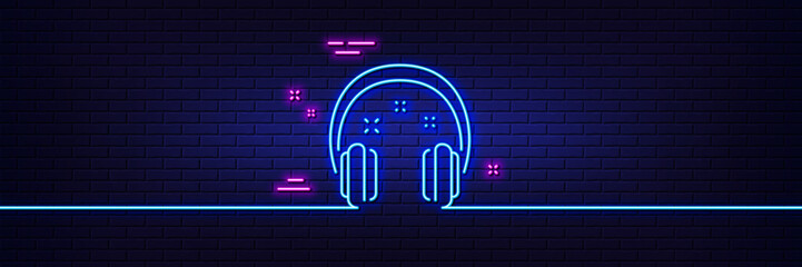 Neon light glow effect. Headphones line icon. Music listen sign. Musical earphones symbol. 3d line neon glow icon. Brick wall banner. Headphones outline. Vector