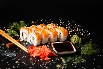 close up of sushi rolls on black tray