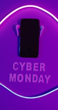 Vertical video of earphones and smartphone with cyber monday text and light on purple background