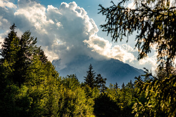The Watzmann in clouds and backlighted. It is the central massif of the Berchtesgaden Alps. He has an altitude of 2713 m and is the third highest mountain in Germany. The massif includes several peaks