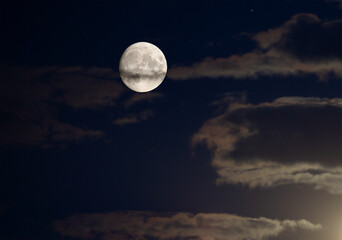 Naklejka na ściany i meble Full moon in the night sky with clouds