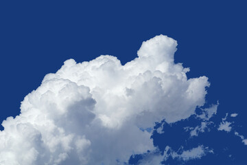 Big white cumulus cloud on the intensive blue sky